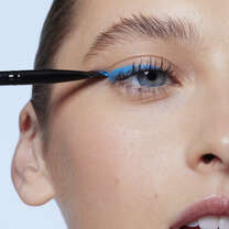 Model Applying Eyeliner with Liner Bush