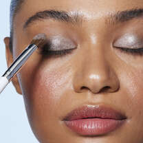 Model Appling Eyeshadow Using Tapered Brush